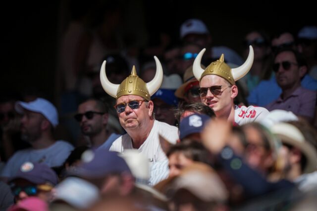 Holger Rune supporters watch the Dane in action