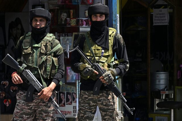 Indian paramilitary troops stand guard on a street in Srinagar in Indian-administered Kash