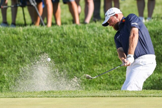 Ireland's Shane Lowry hits out of a bunker on the way to a share of the 54-hole lead at th