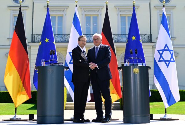 Israeli President Isaac Herzog (L) shakes hands with his German counterpart Frank-Walter S