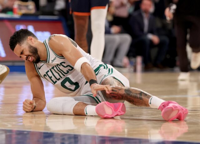 Jayson Tatum grimaces in pain after rupturing his Achilles tendon during Boston's defeat t