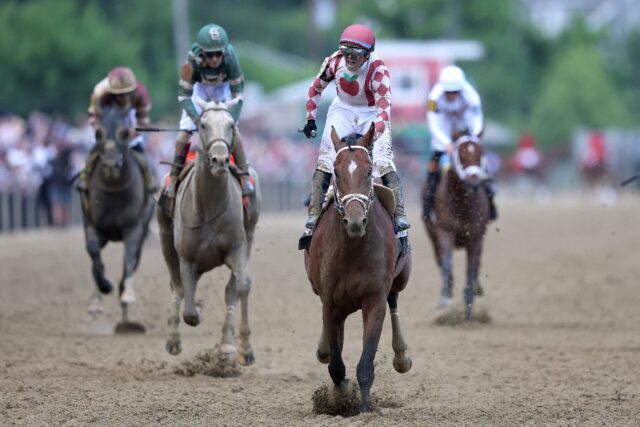Jockey Umberto Rispoli celebrates on Journalism after his victory in the Preakness Stakes
