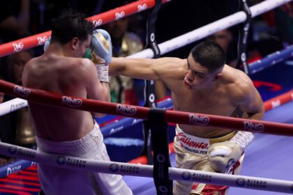 Mexico's Jaime Munguia (R) lands a punch on France's Bruno Surace during their super middl