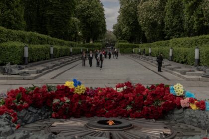 People walk past the Tomb of the Unknown Soldier at the World War II memorial on the Day o
