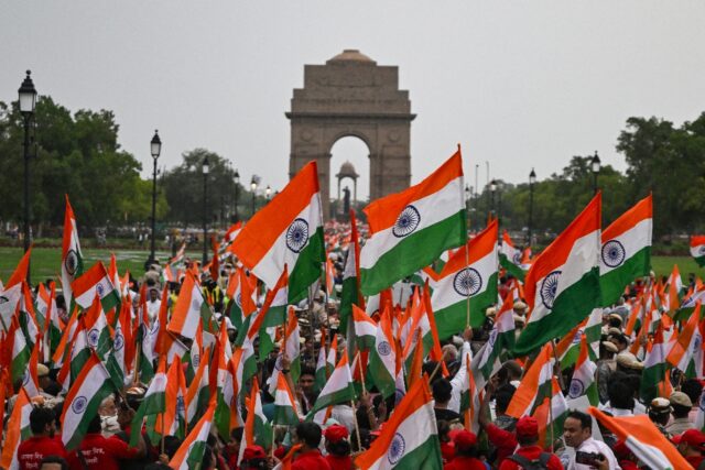 People waving Indian flags take part in a rally in New Delhi expressing solidarity with t