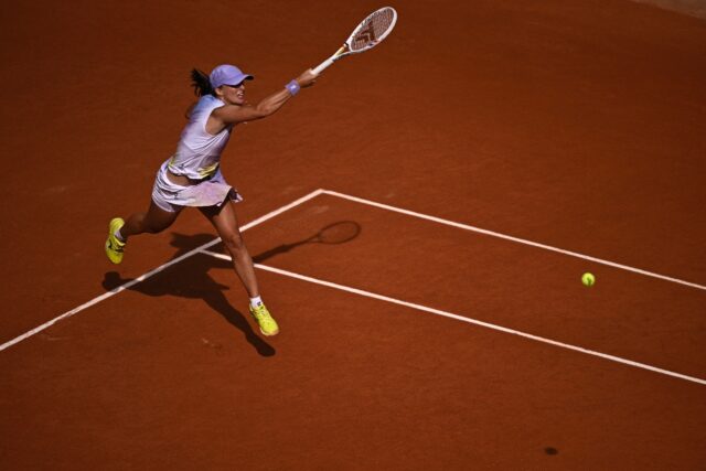 Poland's Iga Swiatek swept past Britain's Emma Raducanu in the second round to keep her bi