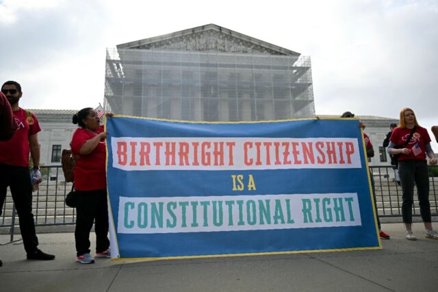 Protestors hold a sign outside the US Supreme Court as it debates President Donald Trump's