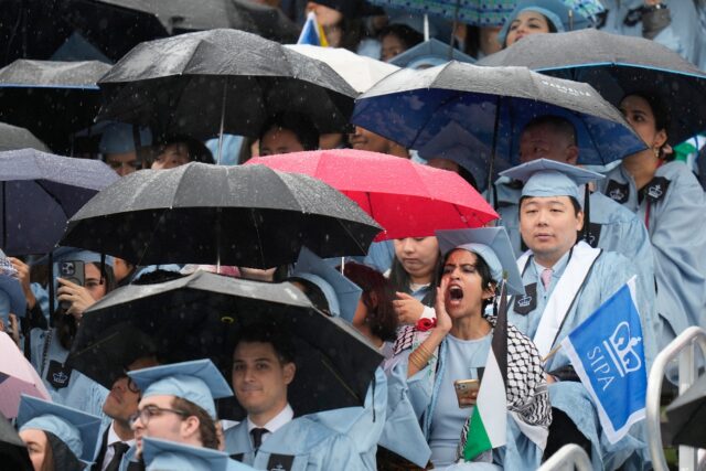 A student boos as Columbia University interim President Claire Shipman speaks during comm