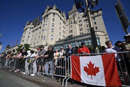 Thousands gathered along a parade route early Tuesday morning for a chance to see their mo