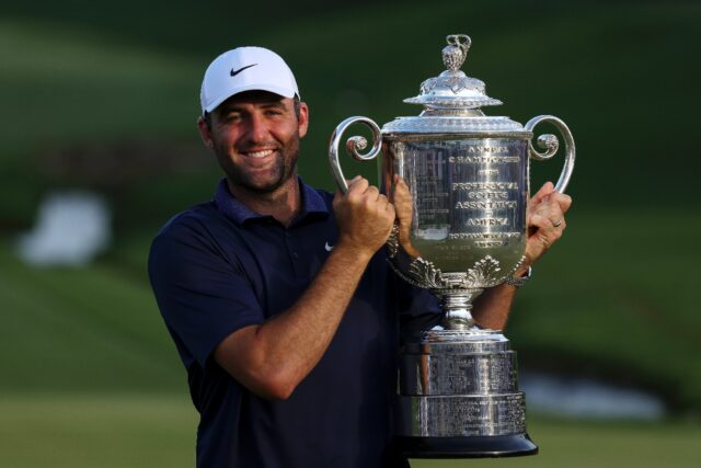 Top-ranked Scottie Scheffler of the United States poses with the Wanamaker Trophy after wi