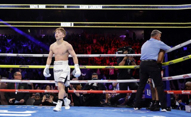 Undisputed super bantamweight champion Naoya Inoue of Japan, at left, walks away as refere