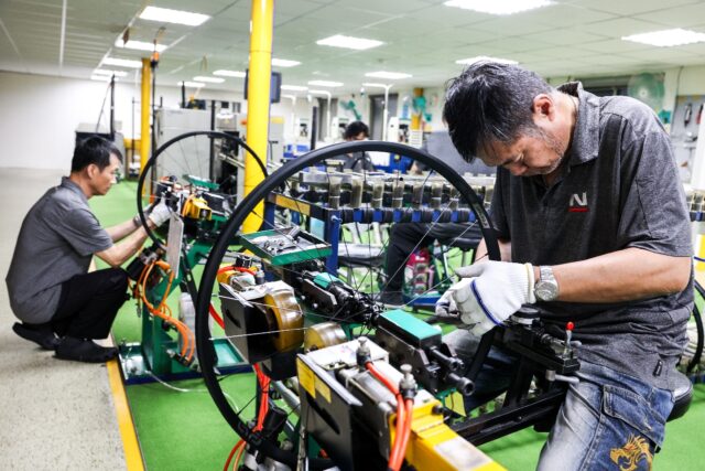 Workers check bicycle wheels at a Joy Group factory in Taichung on April 24, 2025