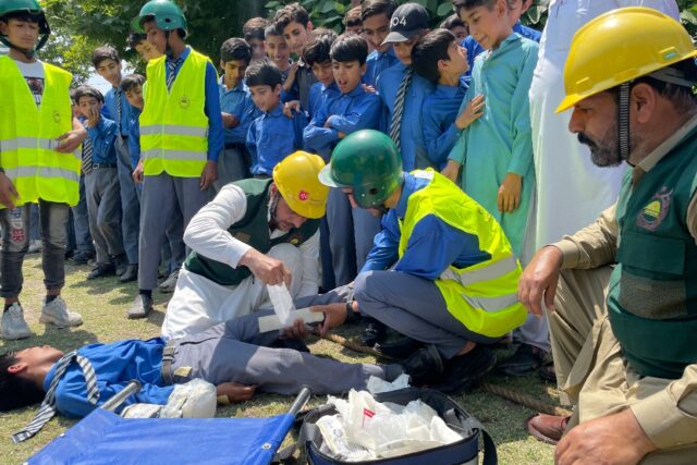 Workers from Pakistan's Civil Defence Department give first aid training for schoolchildre