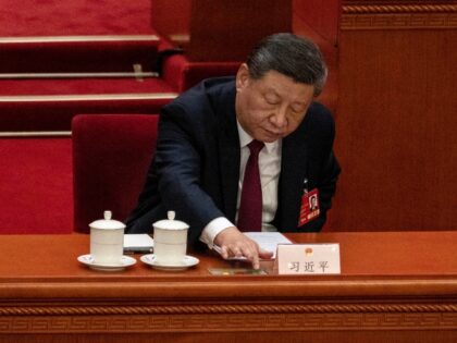 BEIJING, CHINA - MARCH 11: Chinese President Xi Jinping reaches to press the green button