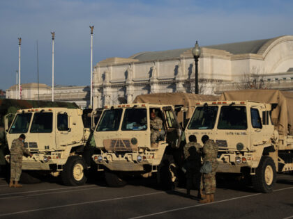 National Guard trucks are parked in a lot in between the U.S. Capitol and Union Station on