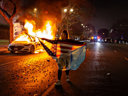 Los Angeles, CA - June 09: A car burns on East 3rd street after protesters set a car on fi