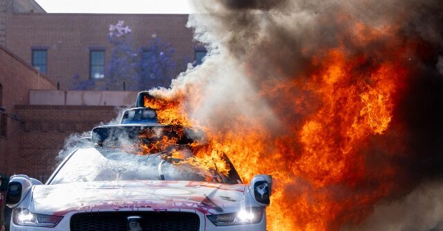 Rioters Torch Waymo Self-Driving Taxis in Downtown L.A.
