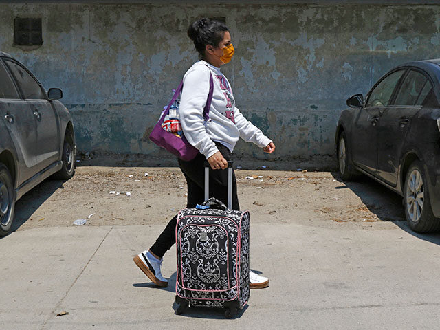 A Honduran migrant who returned voluntarily from the United States walks after arriving at