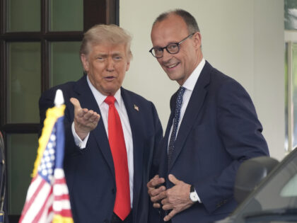 President Donald Trump, left, speaks as he greets Germany's Chancellor Friedrich Merz