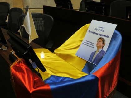 A picture of Colombian Senator Miguel Uribe Turbay and Colombian flag cover his seat at Co