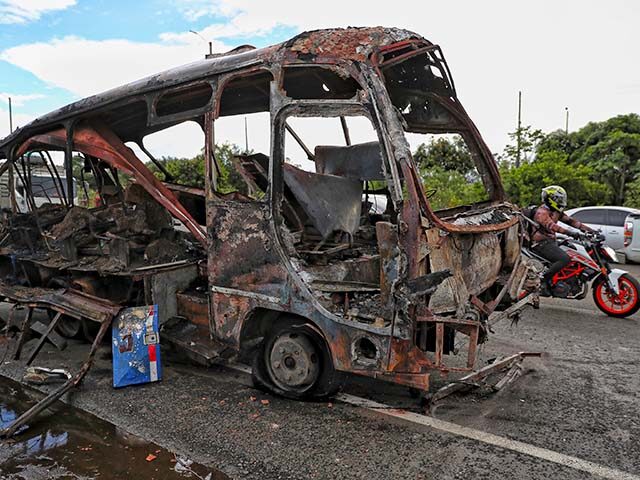 A bus that exploded next to a police station sits on a road in Villa Rica, Cauca, Colombia