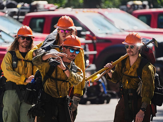 Wildland firefighters with the United States Forest Service prepare at a staging area near