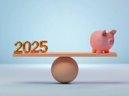 Conceptual image of a pink piggy bank on a seesaw opposite of a 2025 sign in equal balance