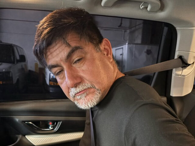 David Huerta in police vehicle after being arrested for interfering with federal officers