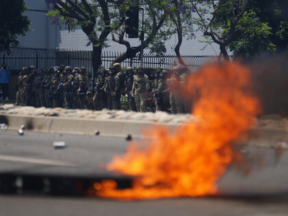 Law enforcement stand during a protest in the Paramount section of Los Angeles, Saturday,
