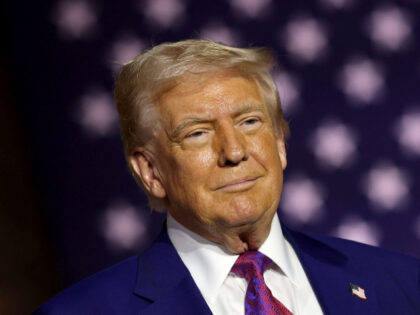 President Donald J. Trump stands on stage as he tours the Al Udeid Air Base on May 15, 202