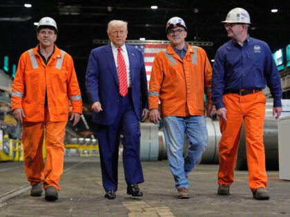 President Donald Trump walks with workers as he tours U.S. Steel Corporation's Mon Va