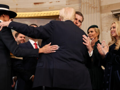 Donald Trump hugs his children after taking the oath of office during inauguration ceremon
