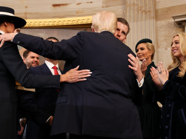 Donald Trump hugs his children after taking the oath of office during inauguration ceremon