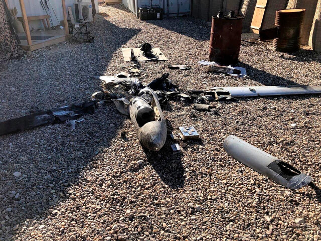 Parts of the wreckage of a drone lie on the ground near the Ain al-Asad airbase in the wes