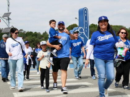 LOS ANGELES, CA - MARCH 27: Fans head to the gates in the parking lot of Dodger Stadium be