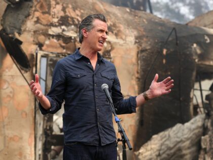 California Governor Gavin Newsom speaks at a press conference while touring areas damaged