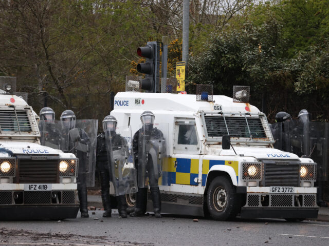 PSNI officers with riot shields on the Springfield road, during further unrest in Belfast.