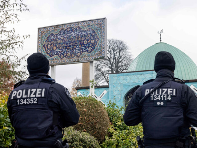 Police officers are pictured during the search of the
