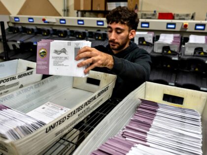 An election worker sorts mail-in ballots for the 2024 Presidential election in Martinez, C
