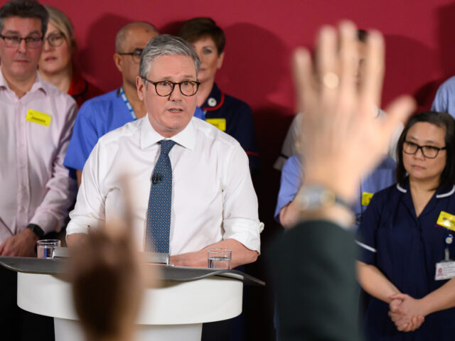 EPSOM, ENGLAND - JANUARY 06: A journalist holds up his hand as UK Prime Minister Keir Star