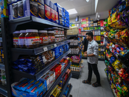 SHARJAH, UNITED ARAB EMIRATES- FEBRUARY 22: A the attendant of 24-hour Mini Market in Al T