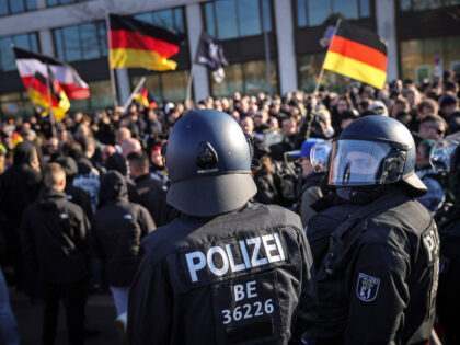 BERLIN, GERMANY - MARCH 22: Far-right activists stand-off with riot policemen as they try