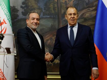 Russia's Foreign Minister Sergei Lavrov (R) shakes hands with Iran's Foreign Minister Abba