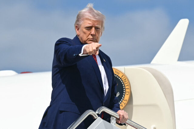 US-POLITICS-TRUMP-DEPARTURE US President Donald Trump points as he boards Air Force One prior to departure from Joint