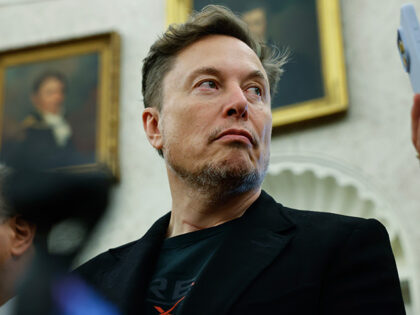 Elon Musk listens as reporters ask U.S. President Donald Trump and South Africa President