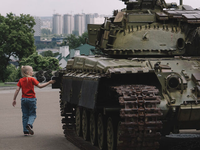 KYIV, UKRAINE - MAY 20: Boy walks by destroyed Russian military machinery displayed in ope