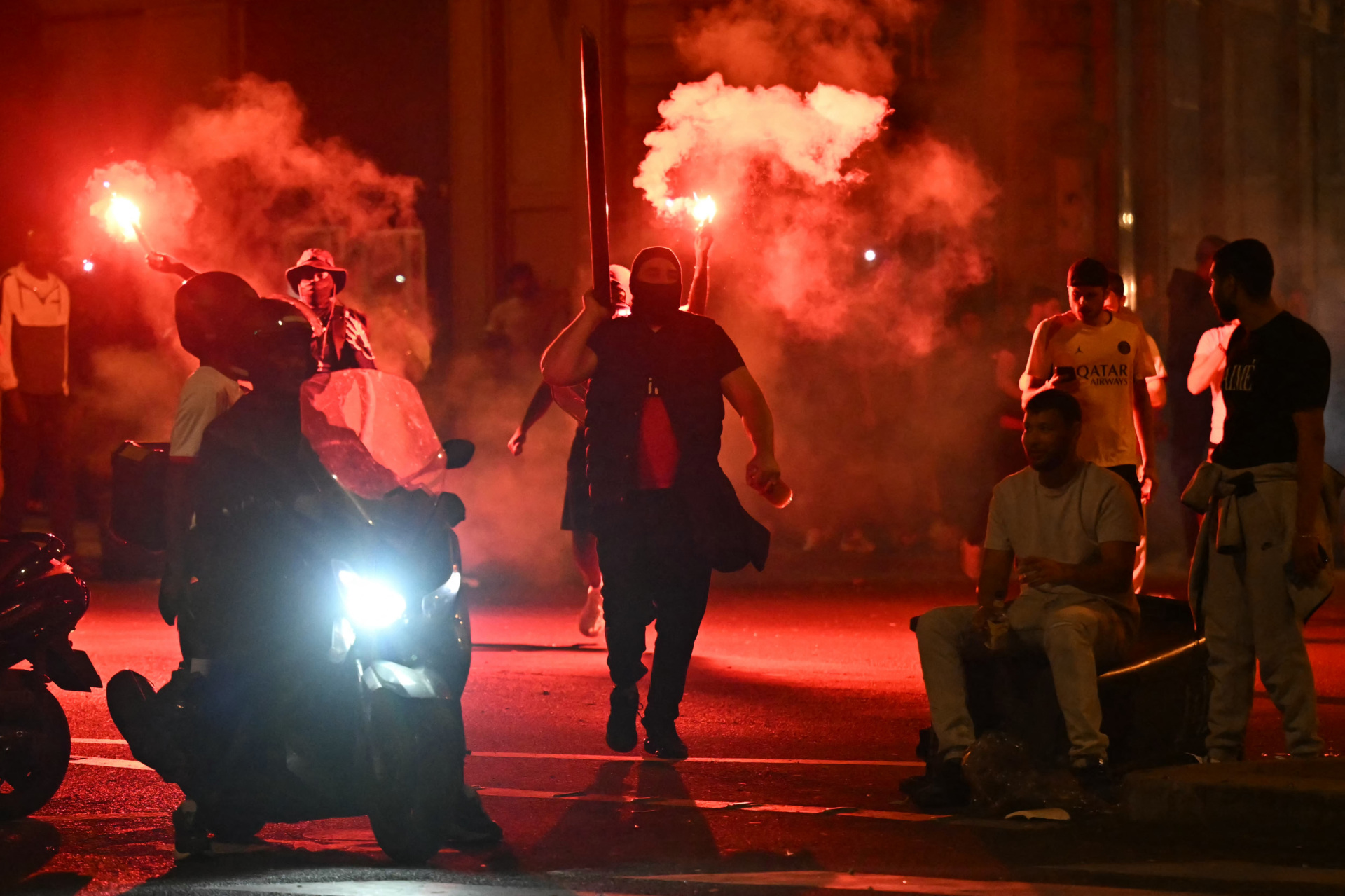 Pendukung Paris Saint-Germain (PSG) berkumpul memegang suar di jalan di Paris awal 1 Juni 2025, selama perayaan setelah kemenangan 5-0 mereka di pertandingan sepak bola final Liga Champions UEFA antara Paris Saint-Germain (PSG) dan Inter Milan diadakan di Munich. (Foto oleh Lou Benoist / AFP) (Foto oleh Lou Benoist / AFP via Getty Images)