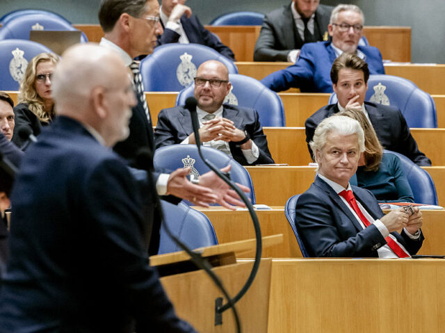 Dutch far-right leader Geert Wilders (R) attends a debate at the House of Representatives