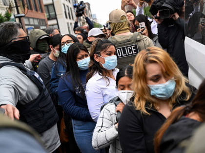 CHICAGO, ILLINOIS - JUNE 4: Immigrants detained by Federal Agents are put into a van outsi