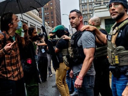 Protestors and ICE agents stand face to face in a tense standoff outside 26 Federal Plaza